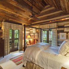Log Cabin Bedroom With Vaulted Ceiling and Glass French Doors