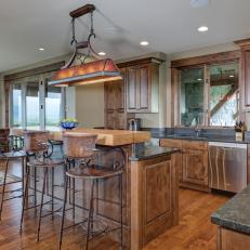Wood Eat-In Kitchen With Large Island and Pool Table Light