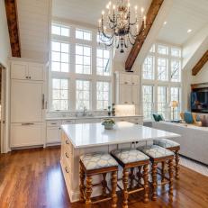 White Open Plan Kitchen With Chandeliers