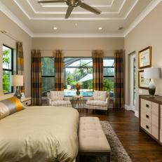 Luxurious Master Bedroom With Golden Tones And Pool Views