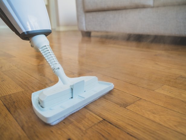 Using a steam mop to clean floors.