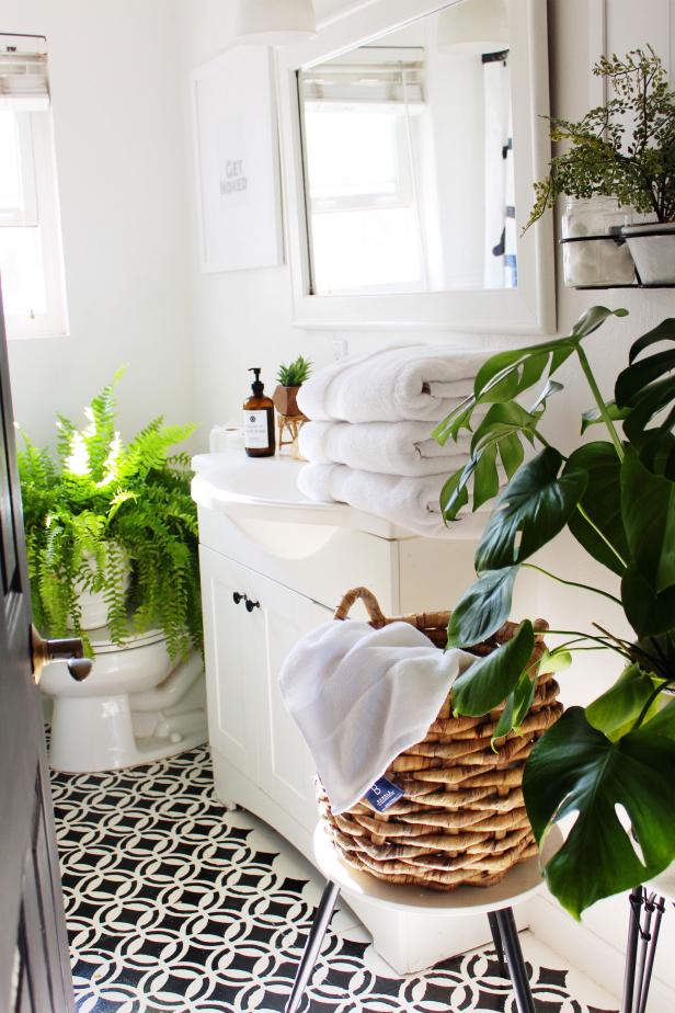 With its focus on functionality and hardwearing materials, the bathroom can be one of the hardest spaces in the home for DIY design. Still, Tamara found a way to put her own stamp on this room over time. “I worked on our house myself over the last few years,” she remembers. “I DIYed open shelves in the bathroom. I also continued my painting venture in the shower, and stenciled the bathroom floors.” The result is a beautiful, spa-type feel from the floor up, accented by lots of bright, leafy green plants.