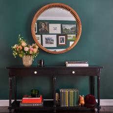 Green Accent Wall With Round Mirror