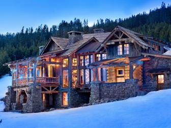 Exterior Of Rustic Chic Cabin On A Snowy Mountainside at Night