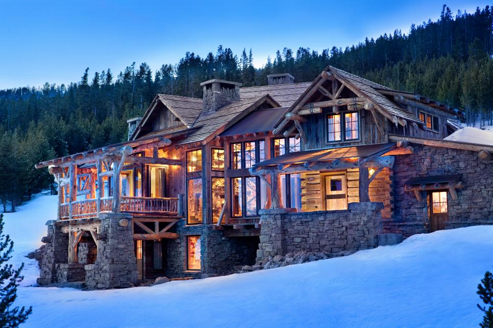 Exterior Of Rustic Chic Cabin On A Snowy Mountainside at Night