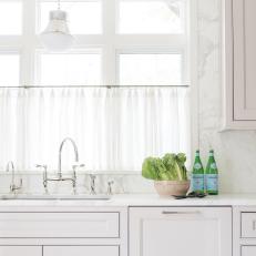 White Kitchen With Green Bottles
