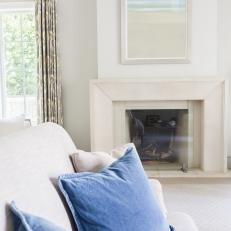 Fireplace and Sofa With Blue Pillows