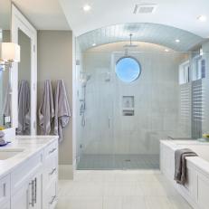 White Coastal Master Bathroom With Porthole