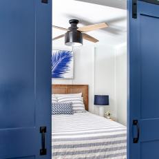 Blue and White Coastal Bedroom With Sliding Door