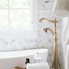 Gold Bathtub Faucet and Wood Stool