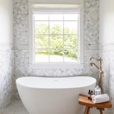 Soaking Tub and Gray Tile Wall