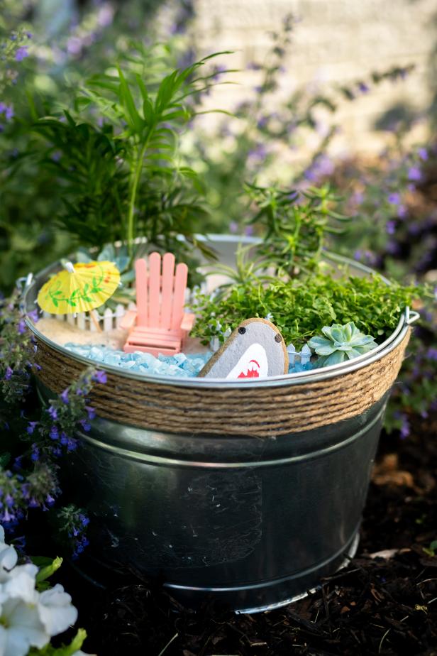 A Galvanized Bucket Filled with Plants and Beach-Themed Decor