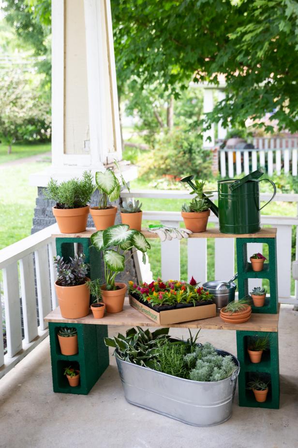 Terra Cotta Pots Sit Atop a Stand Made of Wood and Cinderblocks