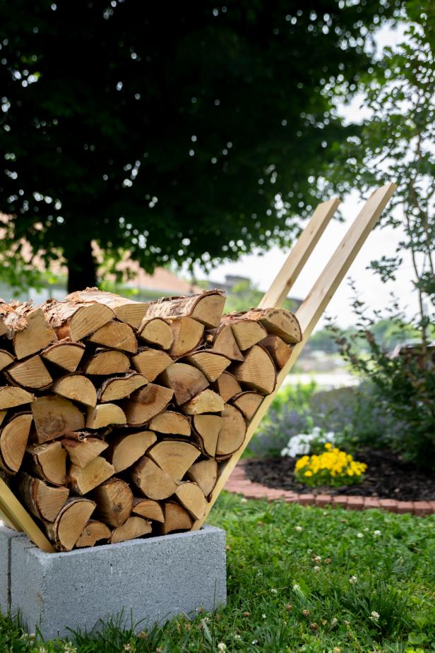 Cinderblocks Hold Boards That Support a Stack of Firewood