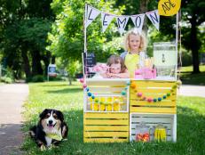 A Lemonade Stand With Two Little Girls and a Dog