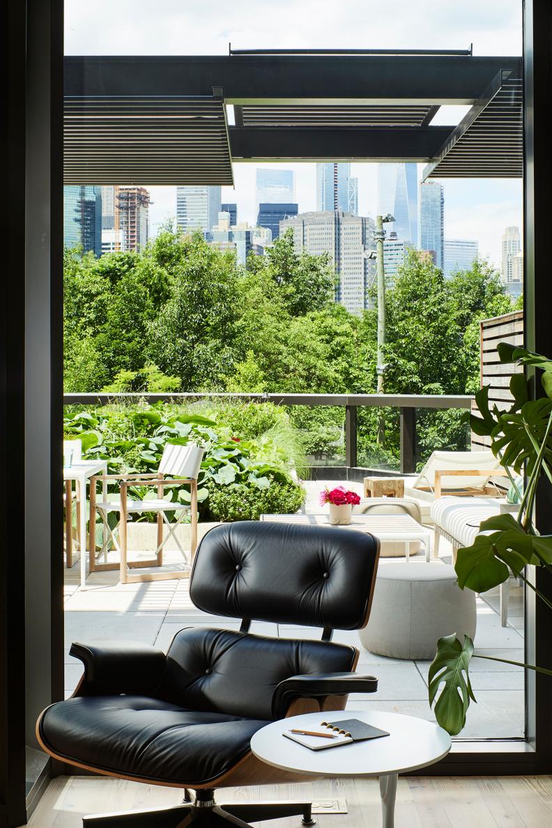 Large Eames Chair Sits In Front Of Window Overlooking NYC Park