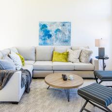 Contemporary White Living Room with Gray Sectional and Green Pillows 