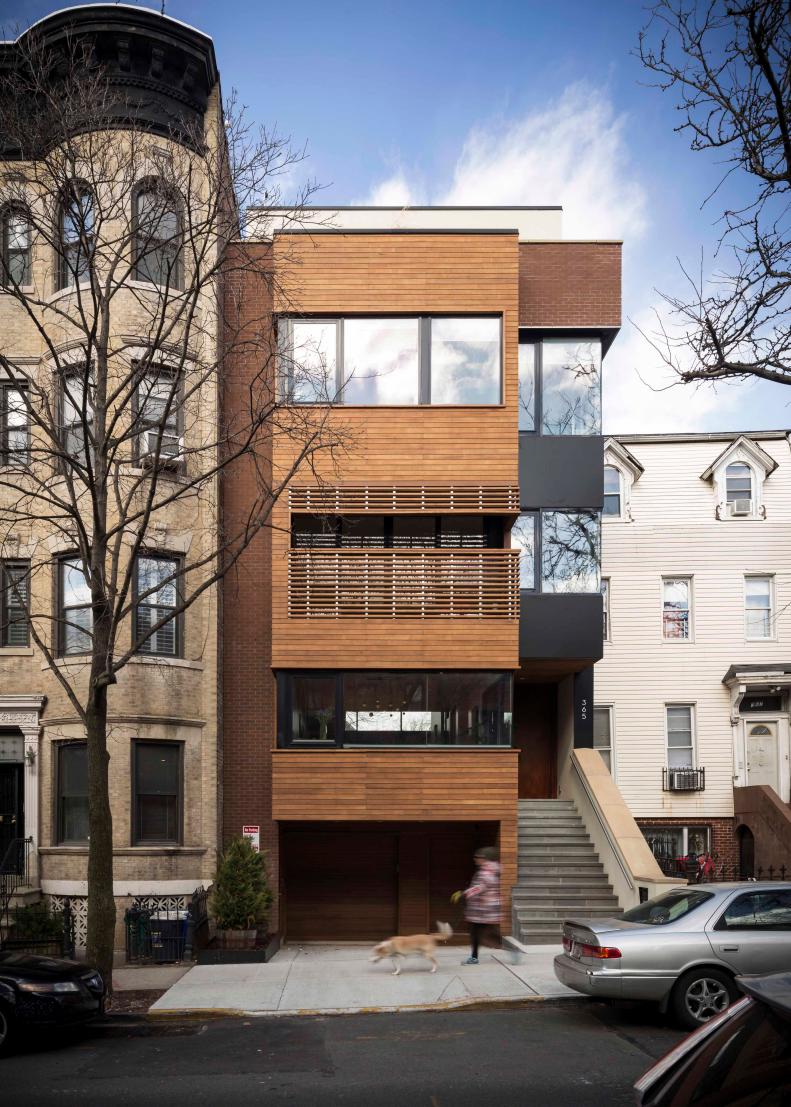 Exterior Shot Of Narrow Townhouse With Hardwood Accents And Porch