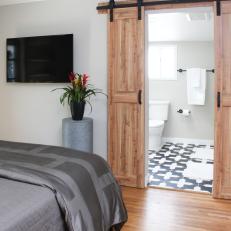 Neutral Rustic Master Bedroom with Brown Sliding Wood Doors 