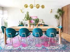Wide View Of Dining Table With Short Velvet Chairs On Patterned Rug