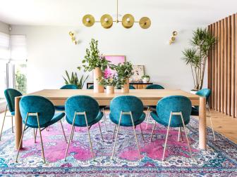 Wide View Of Dining Table With Short Velvet Chairs On Patterned Rug