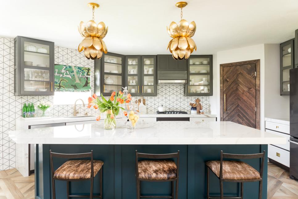 Two Gold-Colored Petal Pendant Lights Hang Above Large Marble Island
