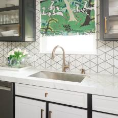 White Kitchen With Marble Countertop And Gold Accents