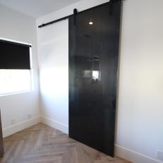 Rustic Neutral Master Bedroom with Black Sliding Barndoor 