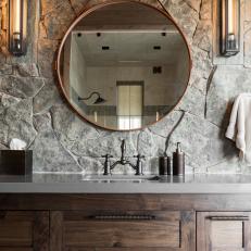 Wooden Vanity With Round Mirror in Master Bathroom