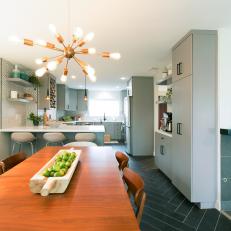 Gray Mid-Century Modern Kitchen and Dining Room with Black Tile Floors 