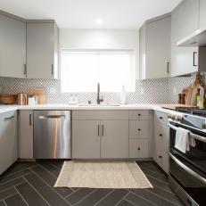 Gray Mid-Century Modern Kitchen with Gray Cabinets and Black and White Tile Backsplash 