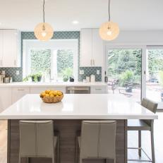 Modern White Kitchen with Gray Island and Chairs 