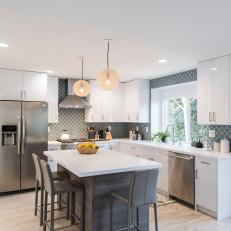 Modern White Kitchen with Gray Island and Gray Chairs 
