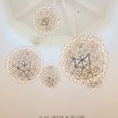 Contemporary White Foyer with Gold Light Fixtures 