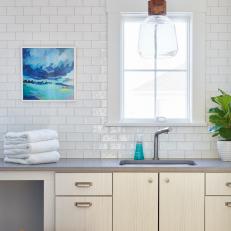 Textured Subway Tile, Glass Pendant Light Add Artisan Look to Laundry Room