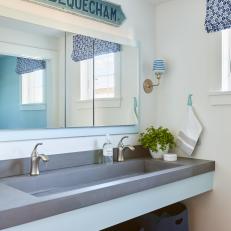 Guest Bathroom Features Concrete Countertop and Trough Sink