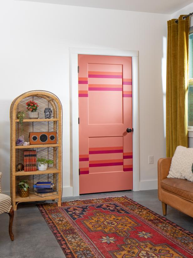 A Stark White Wall With a Bright Striped Pink Door