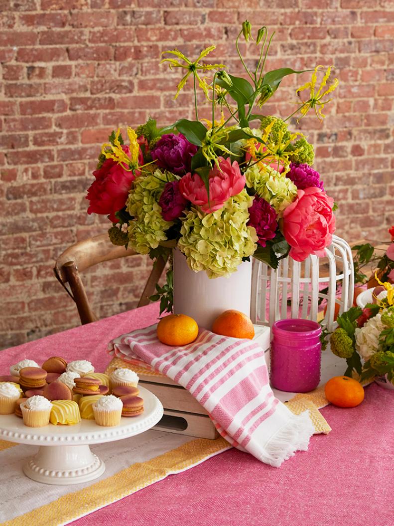 Don’t forget to top off your entertainment space (especially your place setting!) with your own style for a one-of-a-kind feel.

“Incorporating small personalized touches to place settings, like fresh fruit or brightly patterned bowls, is an easy, budget-friendly way to make your table scape feel more intimate and special,” Jenny says.
