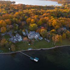 Aerial View of Lakefront Manor Home Surrounded by Trees
