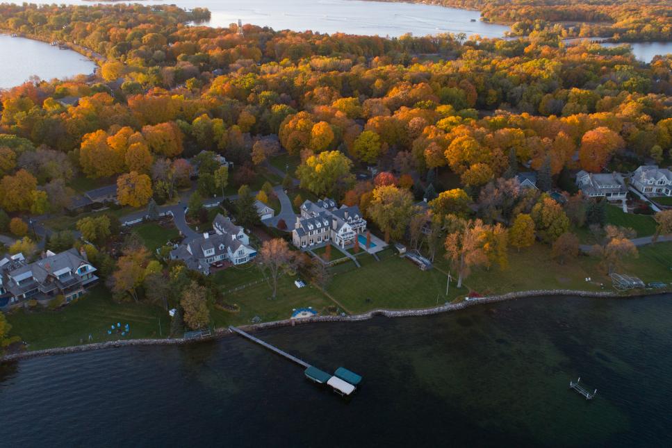 Aerial View of Lakefront Manor Home Nestled Among Autumn Trees