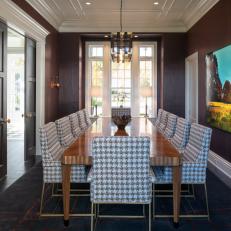 Burgundy Dining Room With Ten-Seat Table and Large Painting