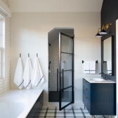 Black and White Bathroom With Tub, Shower Area and Vanity