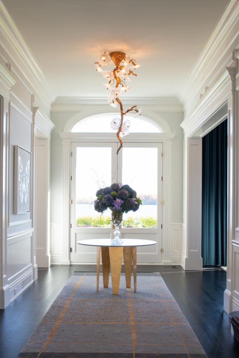 Entryway With Artistic Ceiling Light, Table and Lake View French Doors