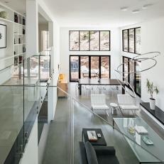 Windows, Glass Panels Allow Light to Travel Through Large Living Space