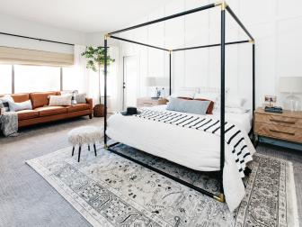 Wide View Of Expansive Bedroom With Four Poster Bed And Leather Sofa