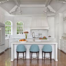 White Cottage Kitchen With Blue Barstools