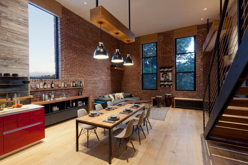 Modern Loft Dining Area with Exposed Brick Walls and Bar