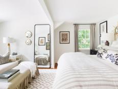 Swathed in neutral colors, this master bedroom is serene and tranquil. Beige and white brushed linens are light and airy and give the room a very casual feel. 

