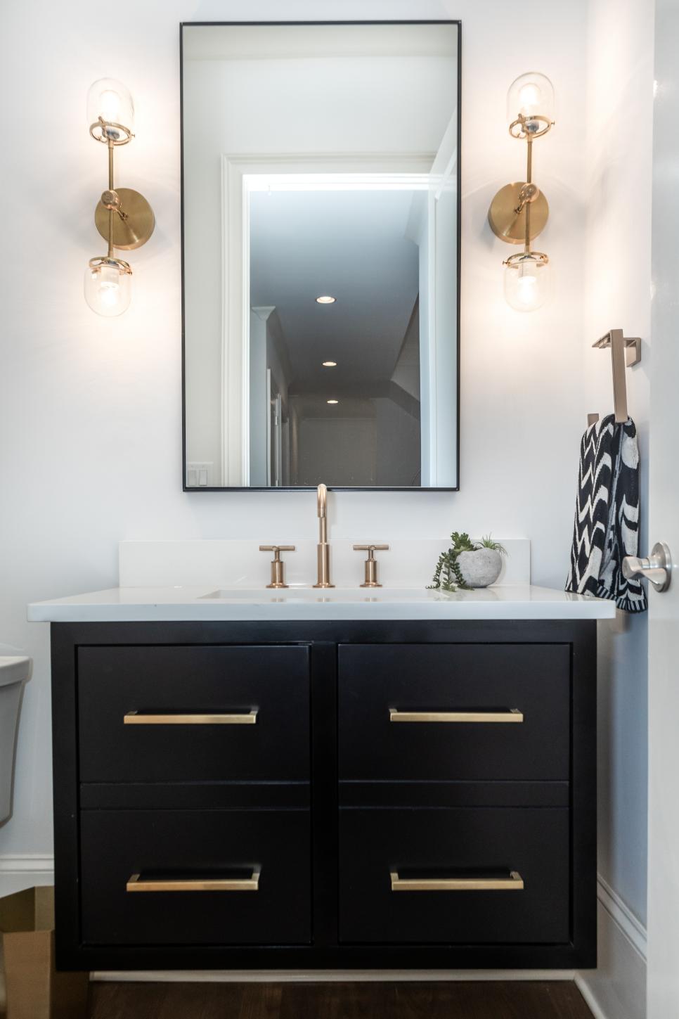 Powder Room Has Black Vanity With Gold-Toned Faucet and Hardware | HGTV