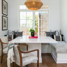 White Transitional Breakfast Nook With Custom Banquette and Pedestal Table